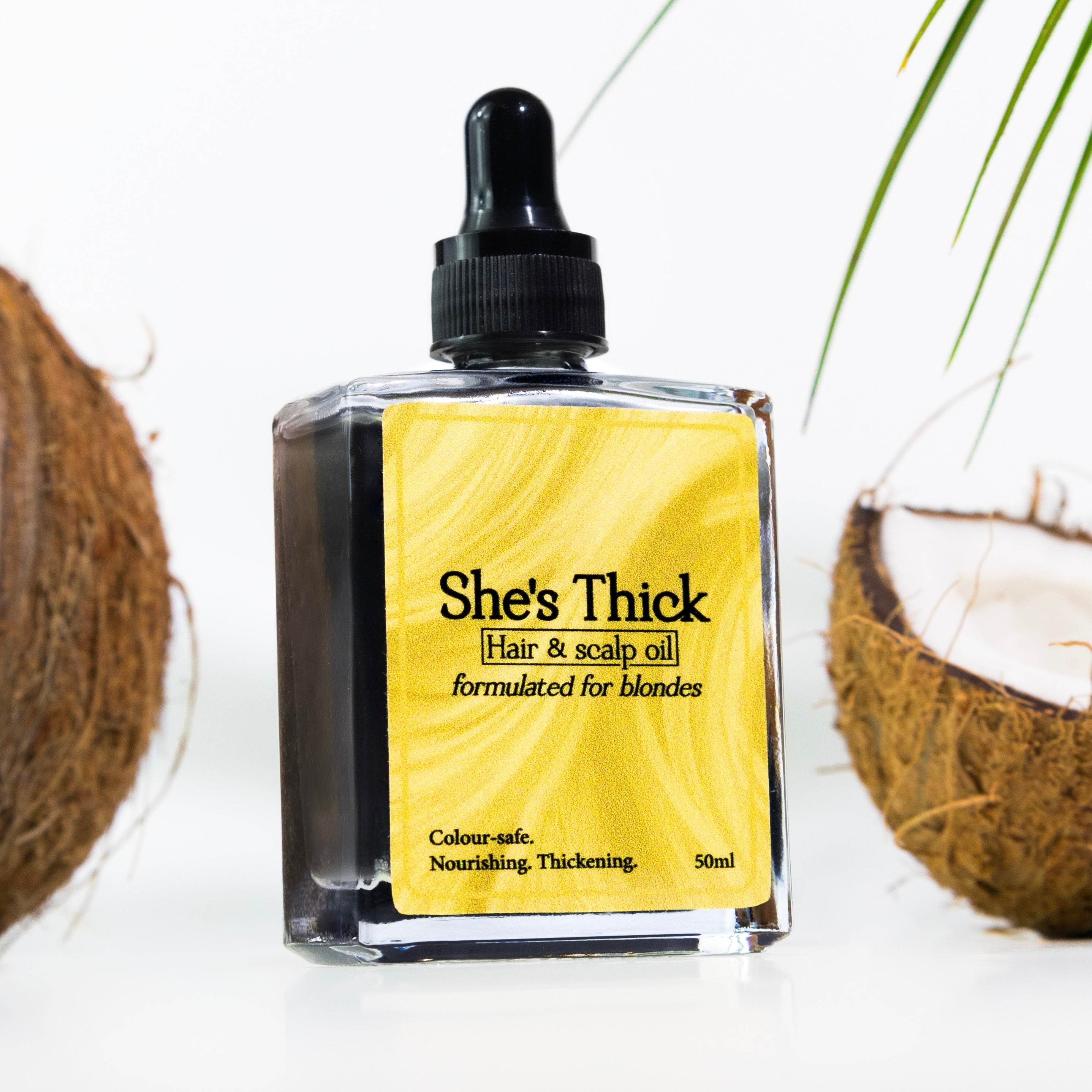 Hair growth oil for blonde hair in glass dropper bottle.